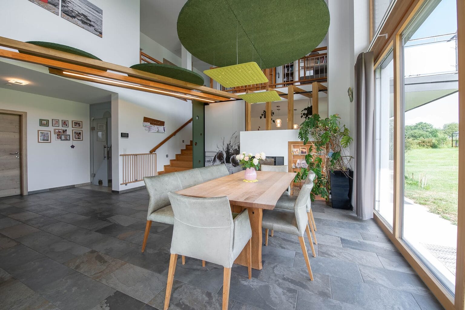 Kreative Raumtrennung und Akustiklösung von Horst Steiner Innenarchitektur für Wohn-/Esszimmer mit Galerie.